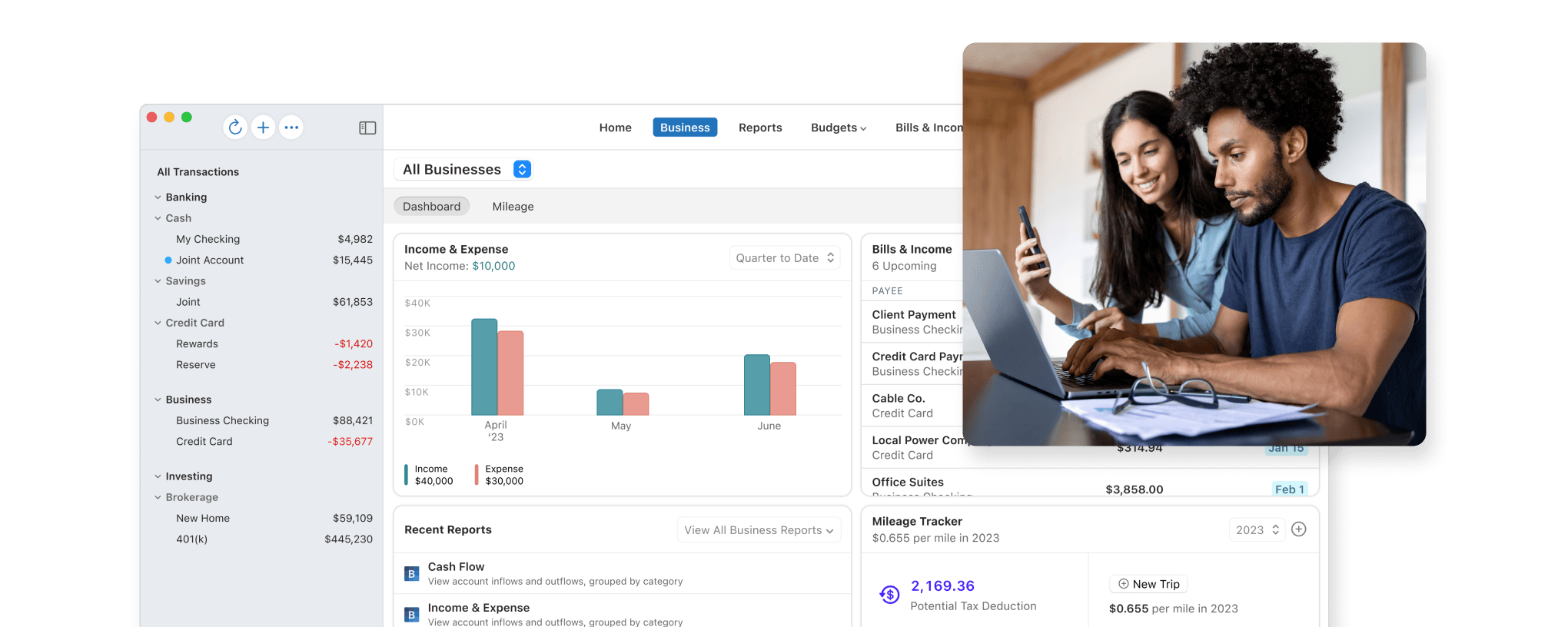 Couple looking at business expenses via Quicken user interface on a laptop